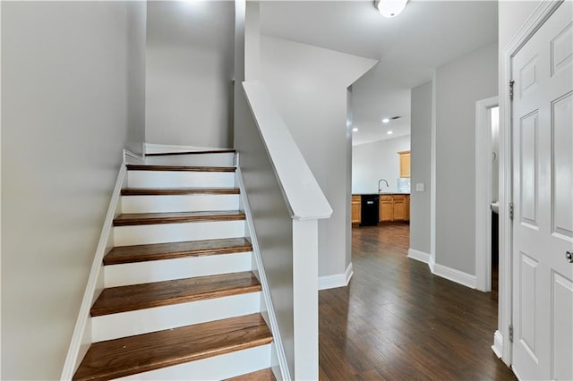 staircase with sink and hardwood / wood-style floors