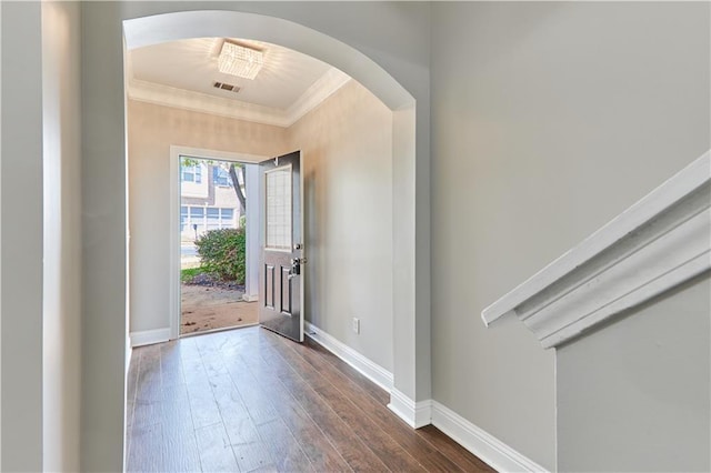 foyer featuring ornamental molding and dark hardwood / wood-style floors