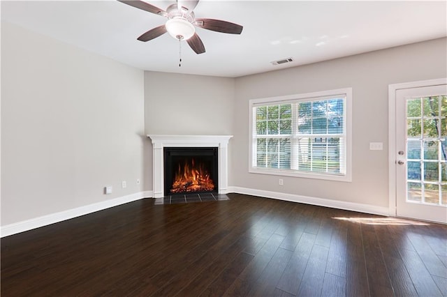 unfurnished living room featuring ceiling fan, dark hardwood / wood-style flooring, and a wealth of natural light