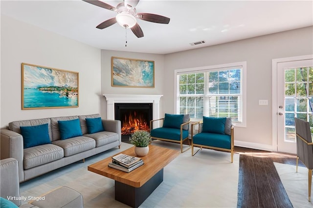 living room with ceiling fan and light hardwood / wood-style flooring