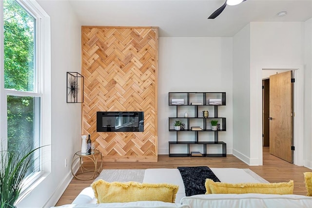 living room featuring ceiling fan, a fireplace, and hardwood / wood-style floors