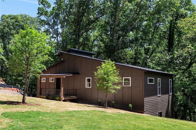 view of side of property with a yard