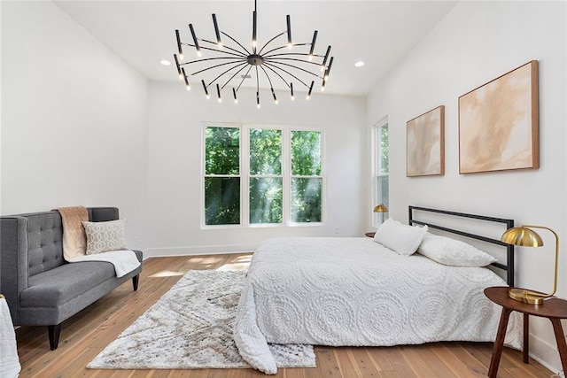 bedroom featuring light hardwood / wood-style flooring and a notable chandelier