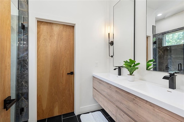 bathroom with vanity, a shower with door, and tile patterned floors