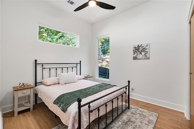 bedroom with ceiling fan and light hardwood / wood-style floors