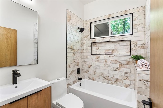 full bathroom featuring toilet, tiled shower / bath combo, and vanity