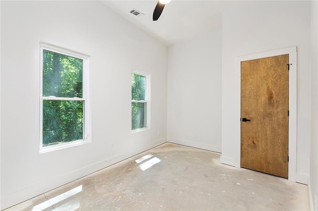 spare room with lofted ceiling, a healthy amount of sunlight, and ceiling fan