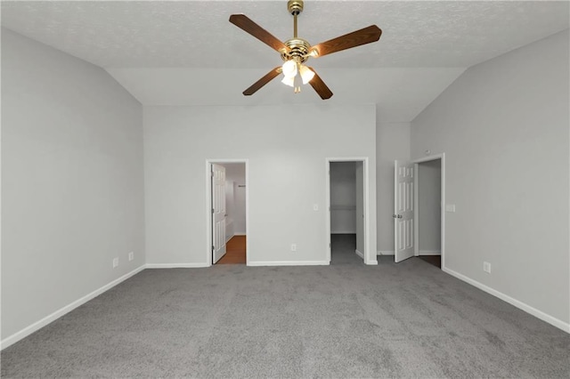 unfurnished bedroom with ensuite bathroom, ceiling fan, vaulted ceiling, and carpet