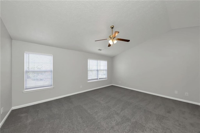 carpeted empty room featuring ceiling fan, a textured ceiling, and lofted ceiling