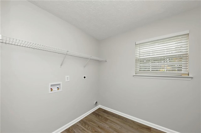 laundry area with hardwood / wood-style floors, hookup for a washing machine, hookup for an electric dryer, and a textured ceiling