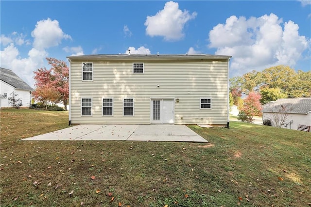 rear view of property with a yard and a patio area