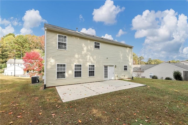 rear view of property with central AC, a patio, and a yard