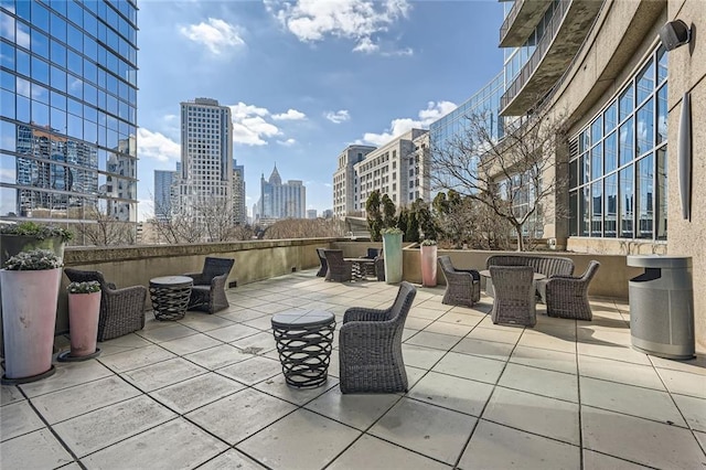 view of patio with outdoor dining area and a city view