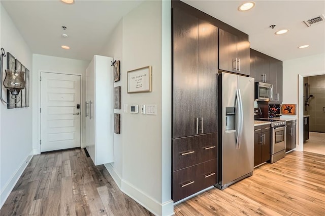 kitchen featuring visible vents, recessed lighting, light wood-style floors, appliances with stainless steel finishes, and light countertops