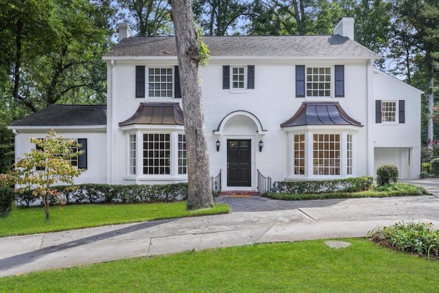 view of front of property with a garage and a front yard