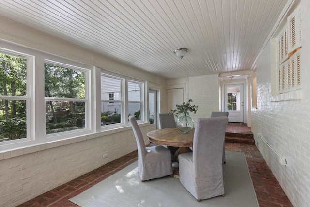 dining space featuring plenty of natural light and wood ceiling