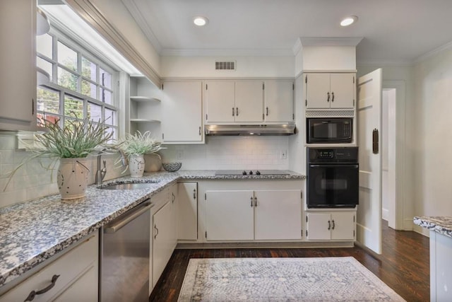 kitchen with black appliances, white cabinets, sink, tasteful backsplash, and light stone counters