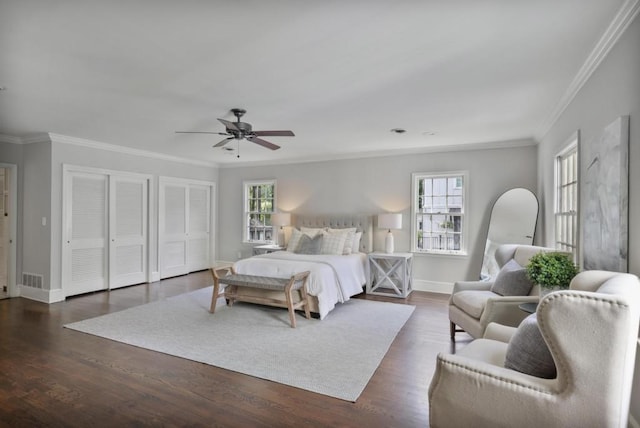 bedroom with multiple windows, dark hardwood / wood-style flooring, ceiling fan, and crown molding