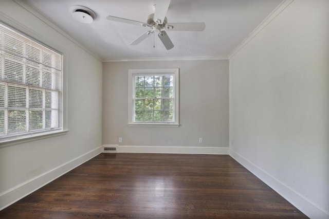 empty room featuring ceiling fan, crown molding, and dark wood-type flooring