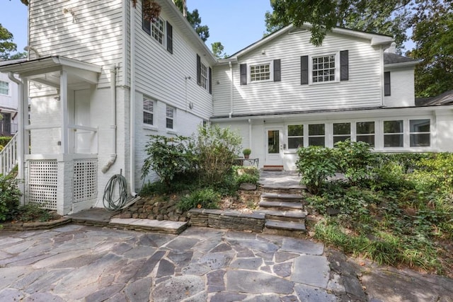 rear view of property featuring a patio area