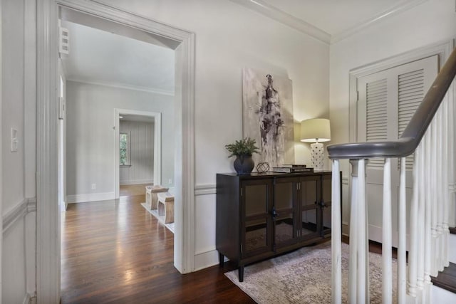 hallway with dark hardwood / wood-style floors and ornamental molding