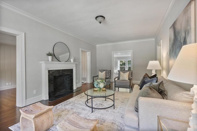 living room with a premium fireplace, crown molding, and dark wood-type flooring