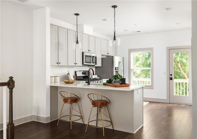 1196 Wylie St SE, Atlanta, GA 30316 - kitchen featuring appliances with stainless steel finishes, a peninsula, light countertops, backsplash, and a sink