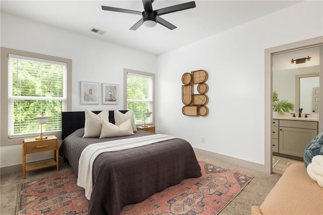 1196 Wylie St SE, Atlanta, GA 30316 - bedroom with multiple windows, light carpet, baseboards, and ensuite bathroom