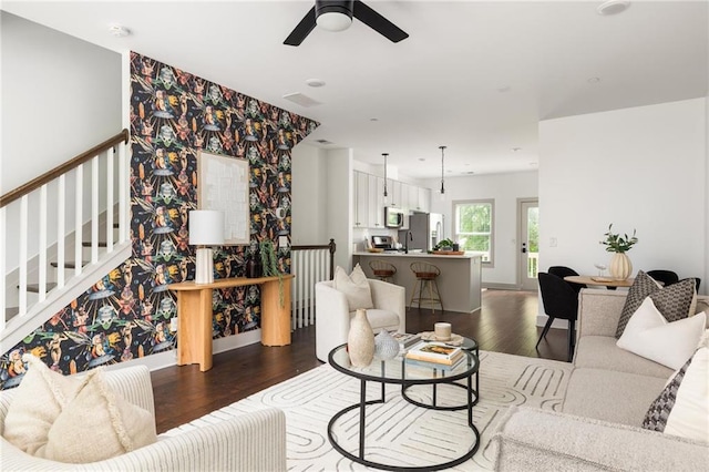 1196 Wylie St SE, Atlanta, GA 30316 - living area with dark wood-style floors, ceiling fan, baseboards, wallpapered walls, and stairs