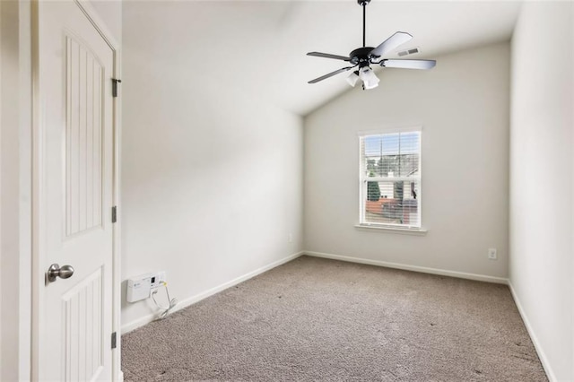 carpeted empty room featuring ceiling fan and lofted ceiling