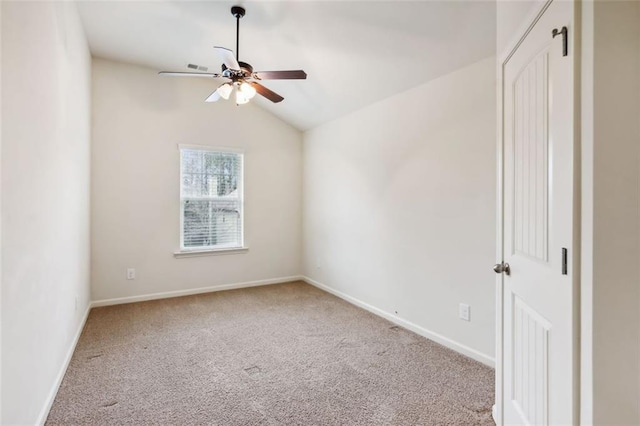 carpeted empty room with ceiling fan and vaulted ceiling