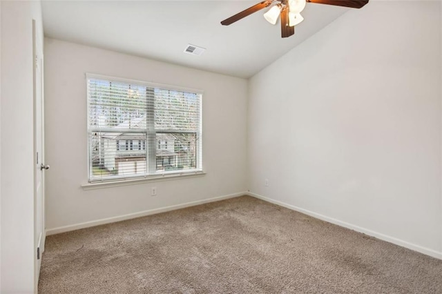 empty room featuring light colored carpet, ceiling fan, and lofted ceiling