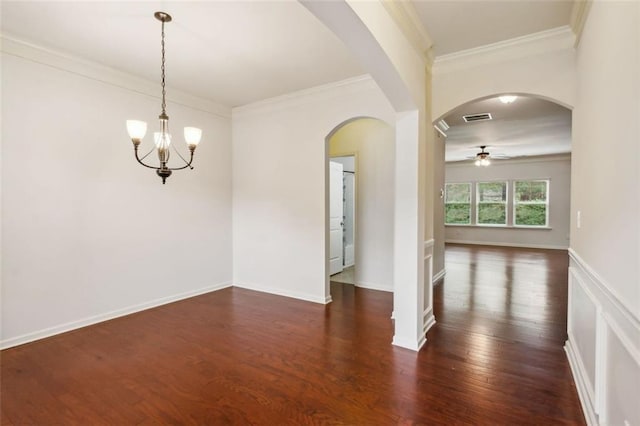 spare room featuring dark hardwood / wood-style floors, crown molding, and ceiling fan with notable chandelier