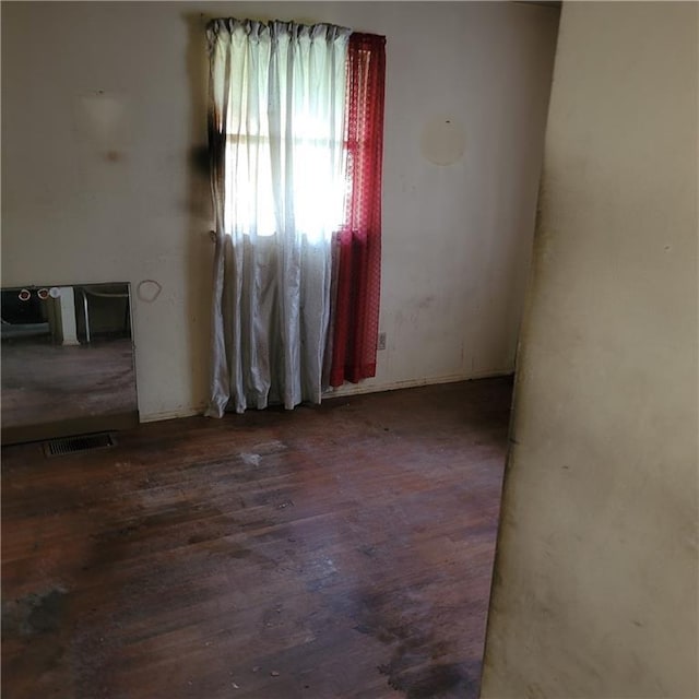 empty room featuring dark hardwood / wood-style flooring