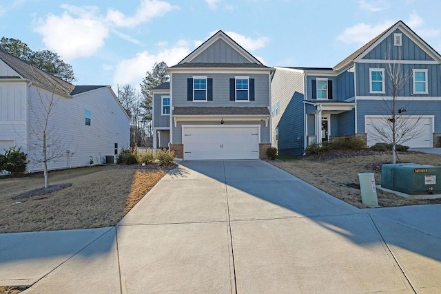 view of front of home with a garage and central air condition unit