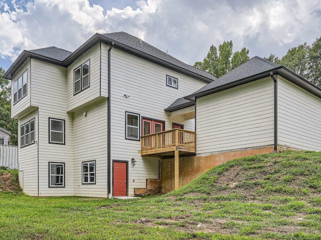 back of house featuring a yard and a deck