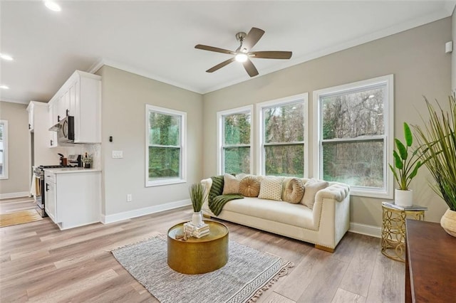 living room with ceiling fan, light hardwood / wood-style flooring, and ornamental molding