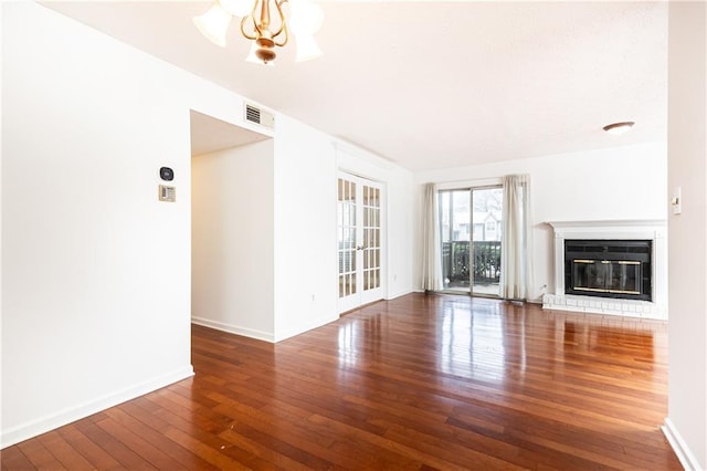 2901 Lenox Way NE Unit 902, Atlanta, GA 30324 - unfurnished living room with hardwood / wood-style floors, a glass covered fireplace, baseboards, and a chandelier