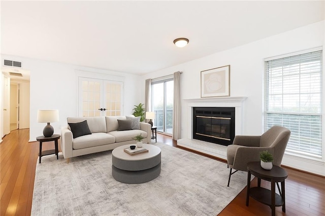 2901 Lenox Way NE Unit 902, Atlanta, GA 30324 - living room featuring hardwood / wood-style floors and a glass covered fireplace