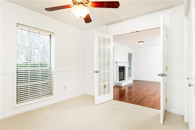 2901 Lenox Way NE Unit 902, Atlanta, GA 30324 - unfurnished room with carpet flooring, a glass covered fireplace, a ceiling fan, and baseboards