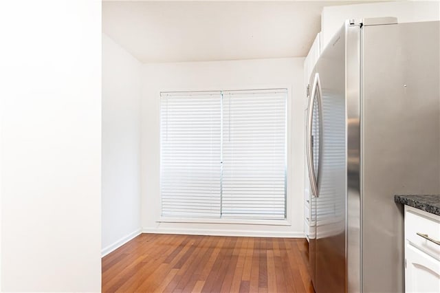 2901 Lenox Way NE Unit 902, Atlanta, GA 30324 - kitchen featuring freestanding refrigerator, baseboards, hardwood / wood-style floors, dark countertops, and white cabinets