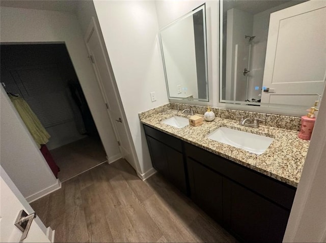 bathroom with vanity, hardwood / wood-style floors, and a shower