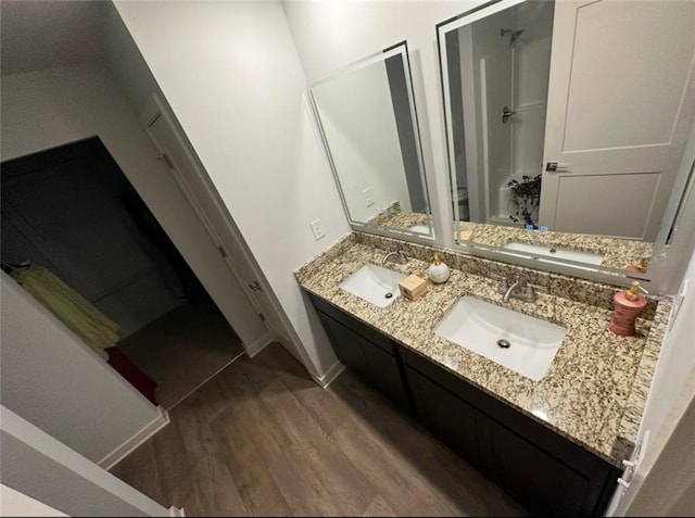 bathroom with vanity, hardwood / wood-style flooring, and a shower