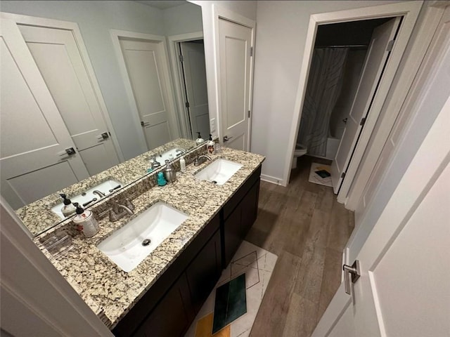 full bathroom featuring vanity, wood-type flooring, toilet, and shower / bath combo with shower curtain