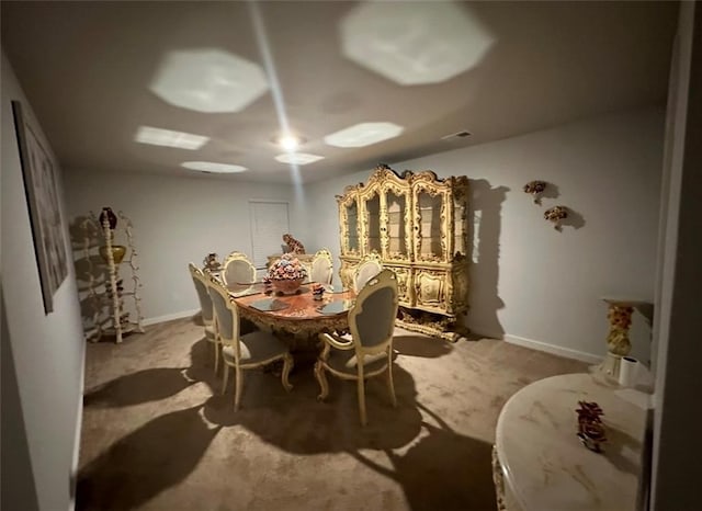 dining space with light colored carpet