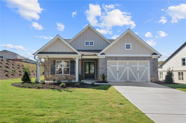 craftsman house featuring a front yard, french doors, and a garage