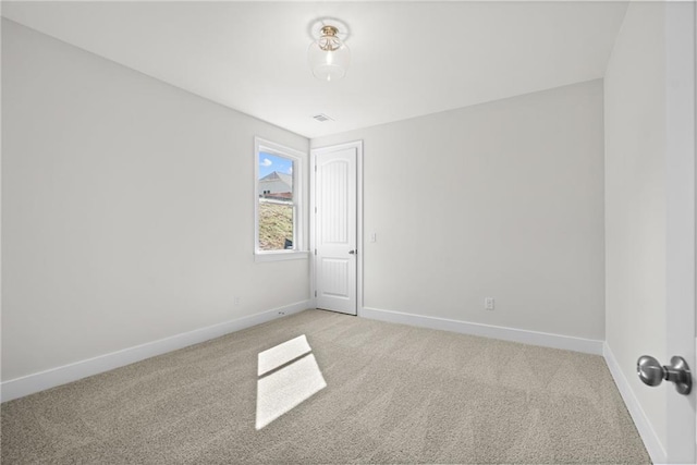 unfurnished room with light colored carpet