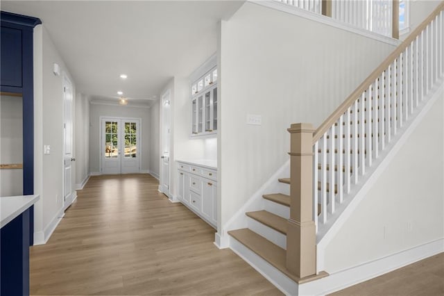 foyer entrance featuring french doors and light wood-type flooring