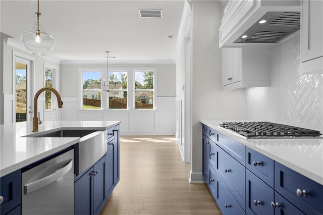 kitchen featuring custom exhaust hood, backsplash, hanging light fixtures, appliances with stainless steel finishes, and plenty of natural light