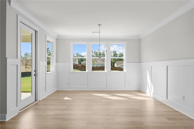 unfurnished dining area with a wealth of natural light and crown molding